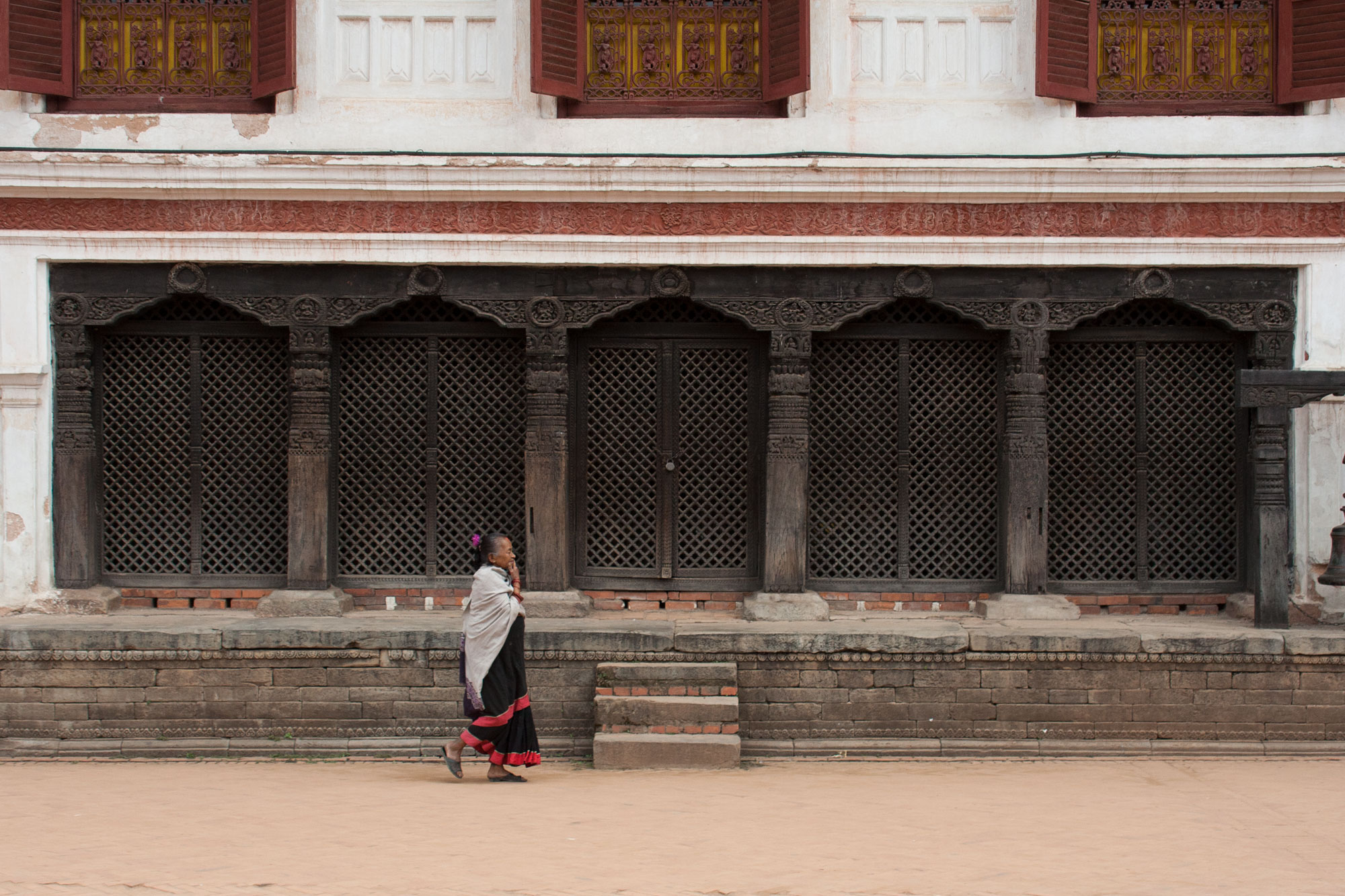 Woman walking past archways