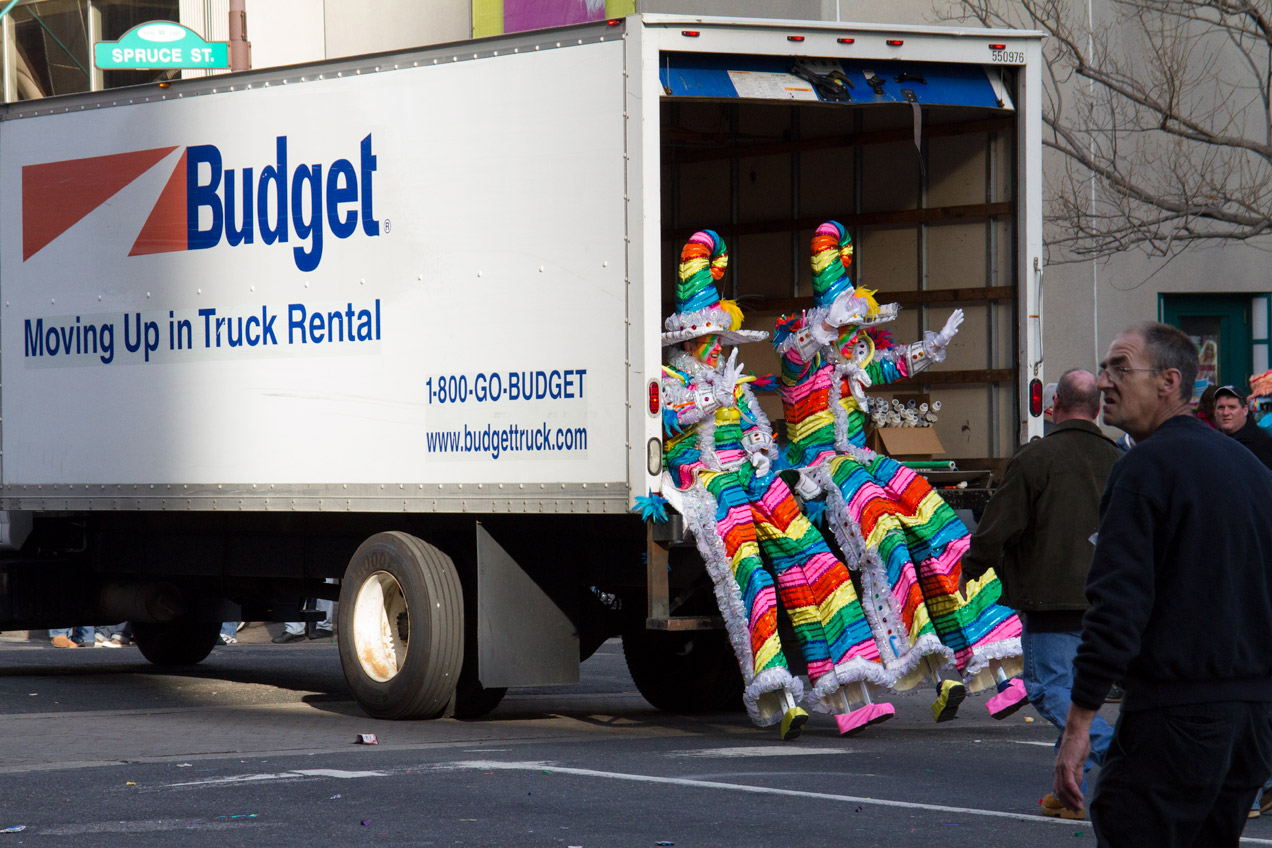 Mummers on stilts taking a break