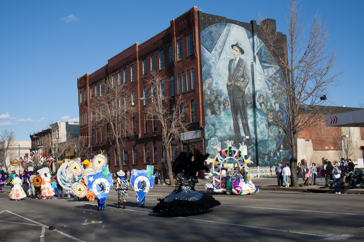 Mummers parading past a Frank Sinatra mural