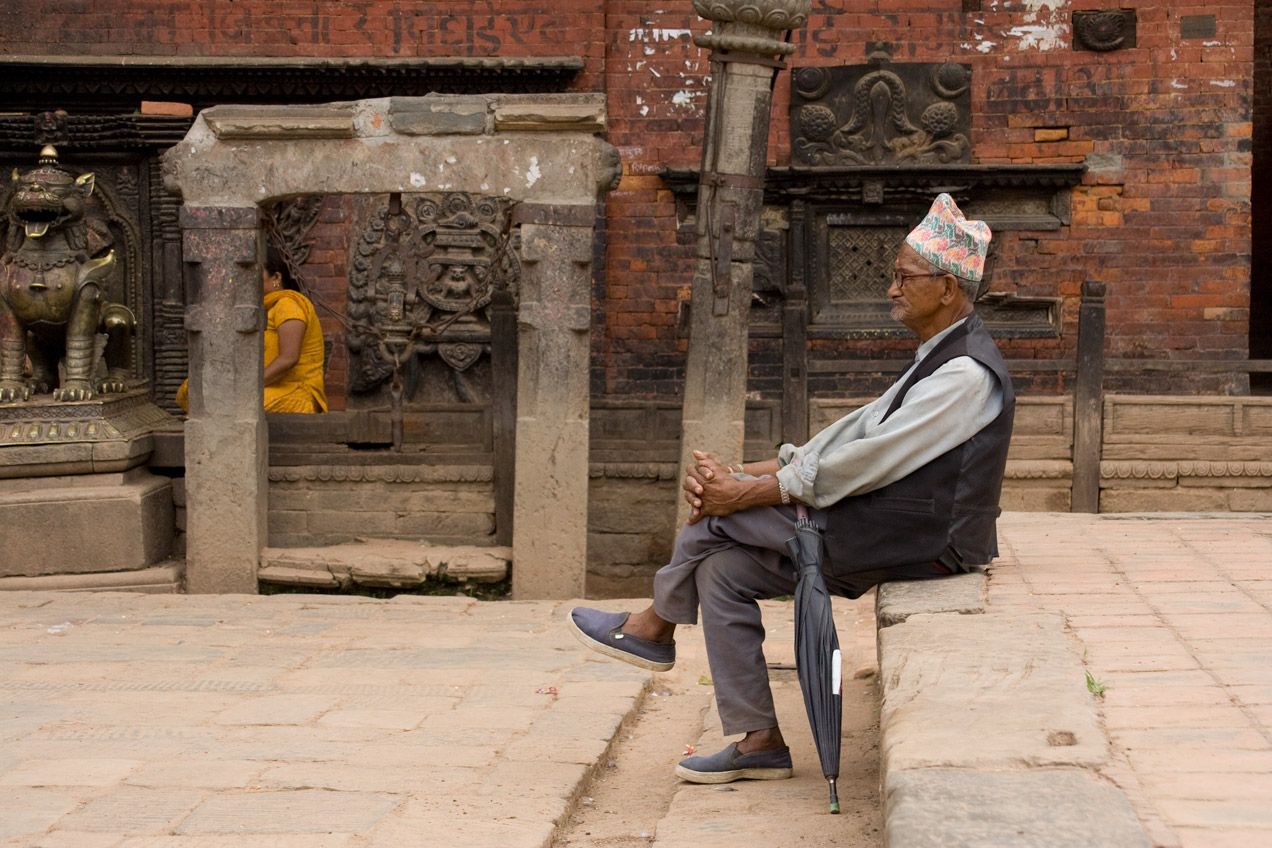 A man waits with his umbrella